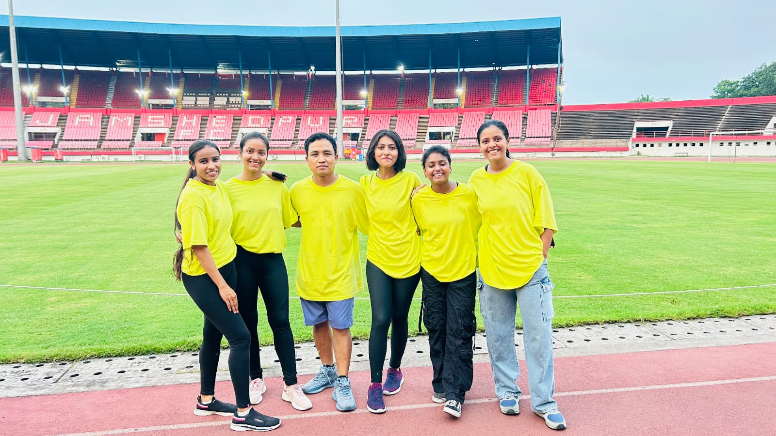 Fitness boot camp with obstacle course, trainers motivating participants, outdoor setting with professional equipment, dynamic group exercise