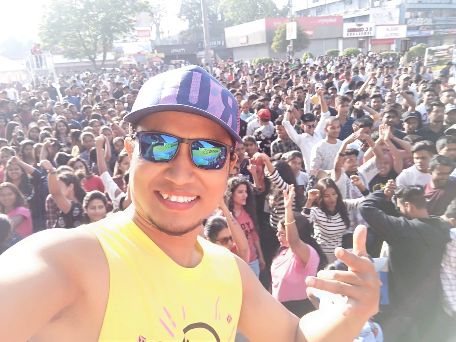 Professional conference setup with modern auditorium seating, projection screens, speaker podium, and delegates attending business seminar