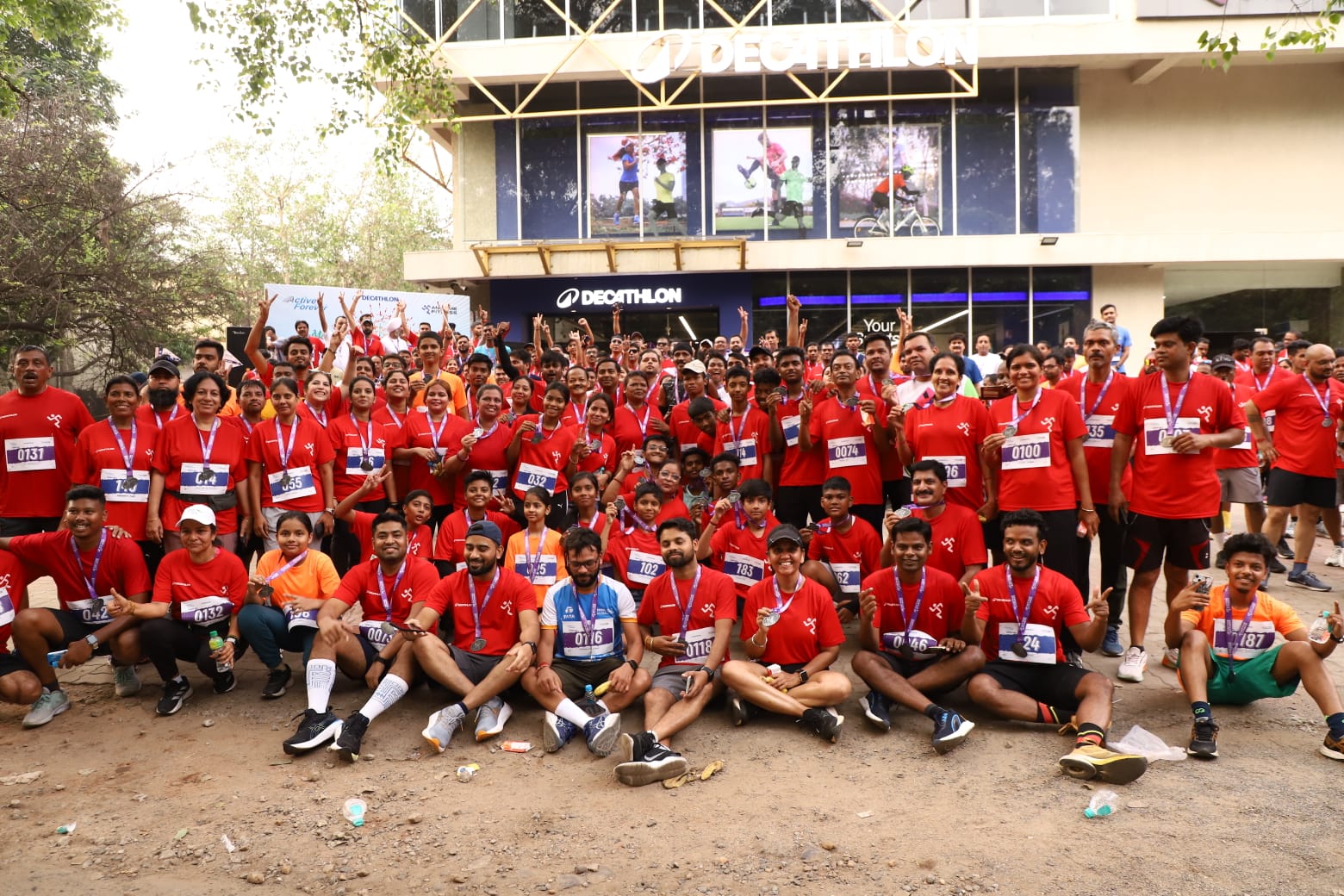 Fitness boot camp with obstacle course, trainers motivating participants, outdoor setting with professional equipment, dynamic group exercise