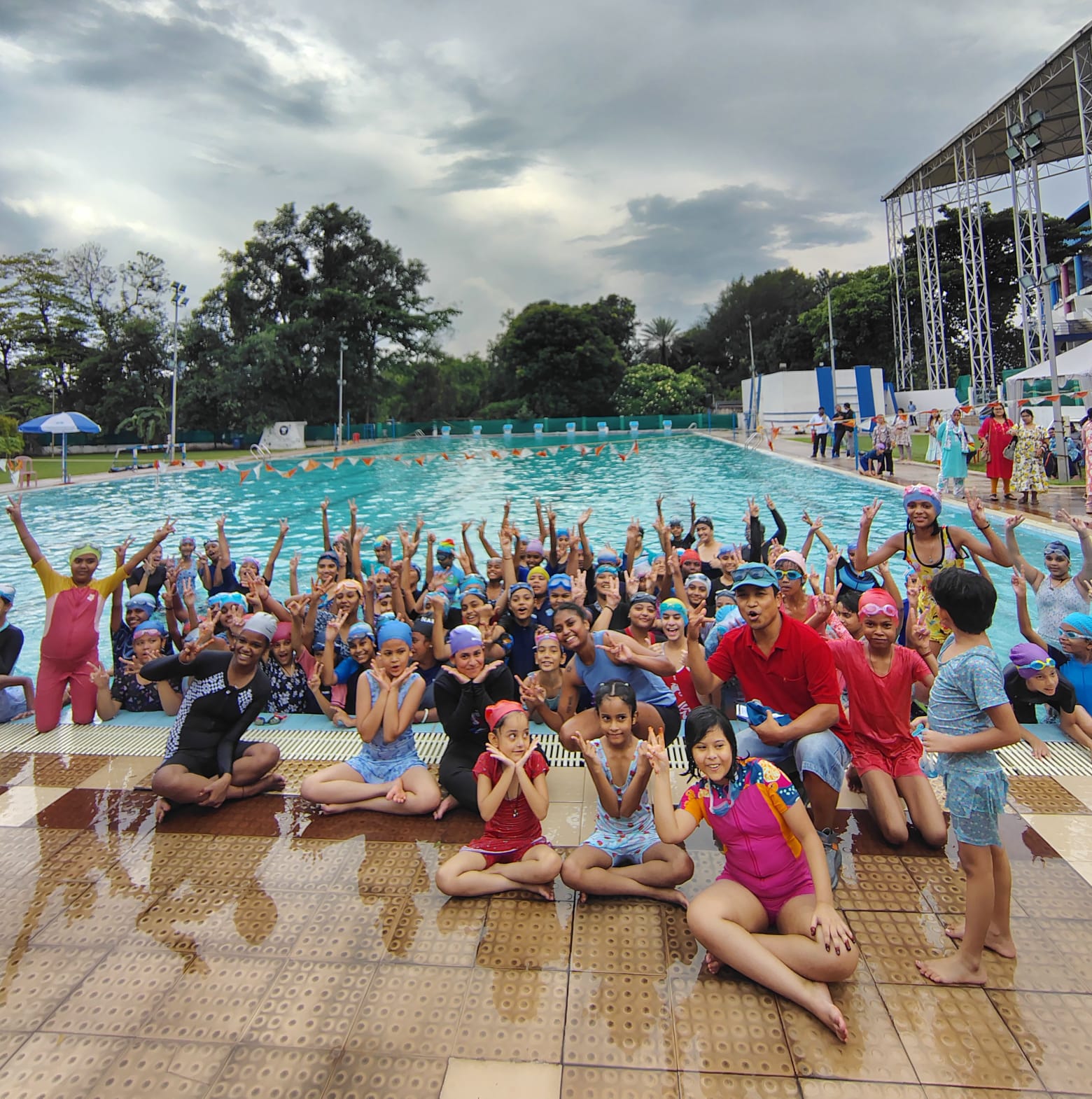 Modern fitness center with people exercising, professional gym equipment, bright natural lighting, and motivational atmosphere showcasing active lifestyle